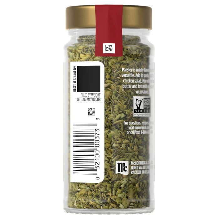 A jar of PC brand dried basil with a label and barcode.