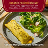 A McCormick Classic French Omelet is presented with a side salad, showcasing a tender and silky egg preparation.