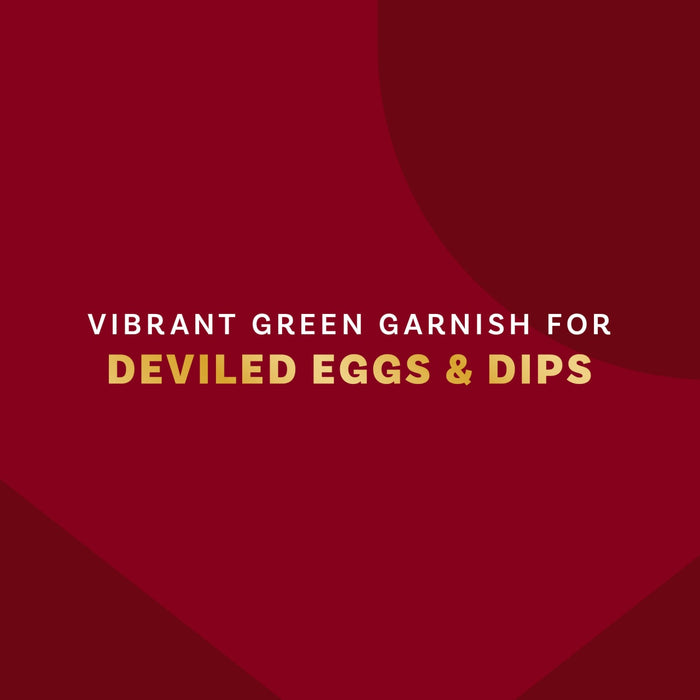 A vibrant green garnish for deviled eggs and dips is displayed against a deep red background.