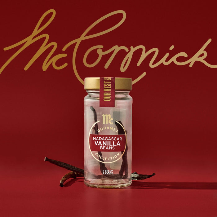 A jar of McCormick Gourmet Vanilla Beans is displayed against a red background with the McCormick logo in gold script.