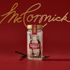A jar of McCormick Gourmet Vanilla Beans is displayed against a red background with the McCormick logo in gold script.