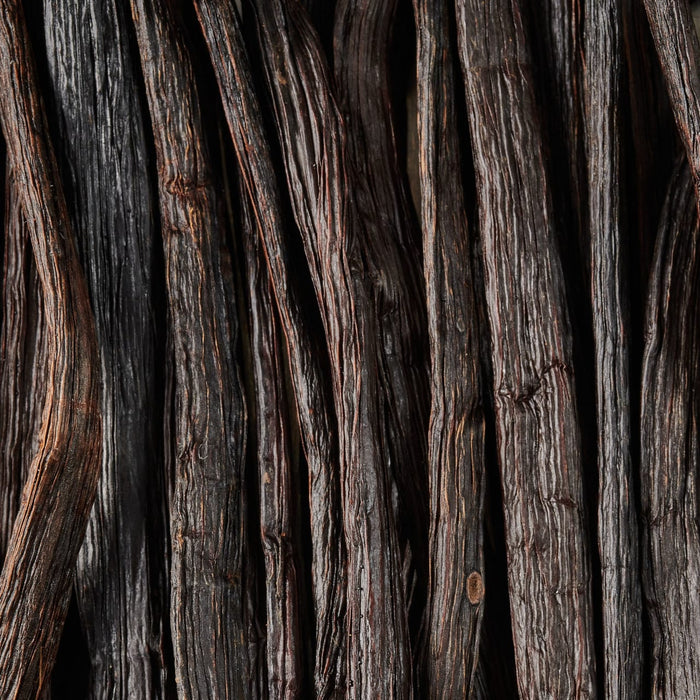 A close-up of dark brown vanilla beans showing their rich texture.