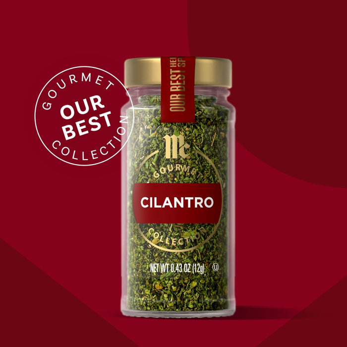 McCormick Gourmet Cilantro, part of the Our Best Collection, is displayed in a glass jar with a gold lid.