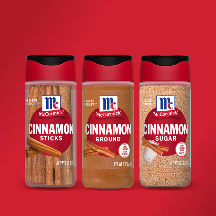 Three McCormick spice jars, one with cinnamon sticks, one with ground cinnamon, and one with cinnamon sugar.