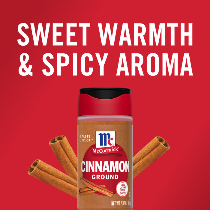 A bottle of McCormick Cinnamon Ground with cinnamon sticks on a red background.
