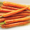 A close-up of several roasted carrots with a brown sugar glaze.