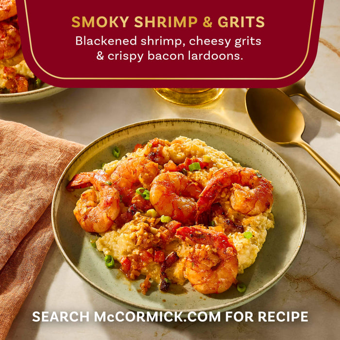 A plate of McCormick's Smoky Shrimp and Grits featuring blackened shrimp, cheesy grits, and crispy bacon lardons.