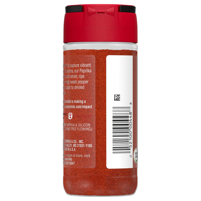 A glass jar of McCormick Paprika with a red lid.