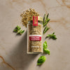 A jar of McCormick Italian Herb Seasoning is surrounded by fresh basil and rosemary sprigs, highlighting the product's natural ingredients.