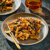 A plate of pasta with vegetables and sauce is shown, highlighting a delicious and appetizing meal.