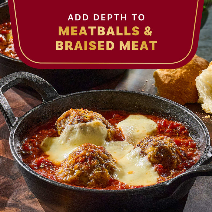 A close-up shot of meatballs and braised meat in a rich sauce, highlighting the depth of flavor.