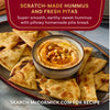 A bowl of scratch-made hummus and fresh pitas from McCormick is displayed.