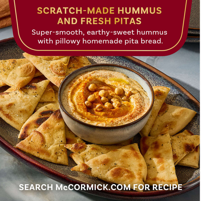 A bowl of scratch-made hummus and fresh pitas from McCormick is displayed.