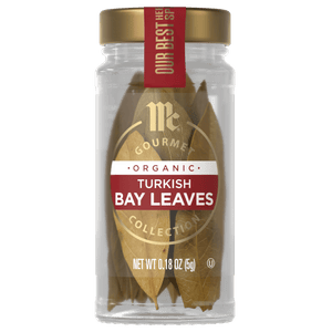 A jar of McCormick Gourmet Organic Turkish Bay Leaves is displayed, showcasing the products branding and contents.