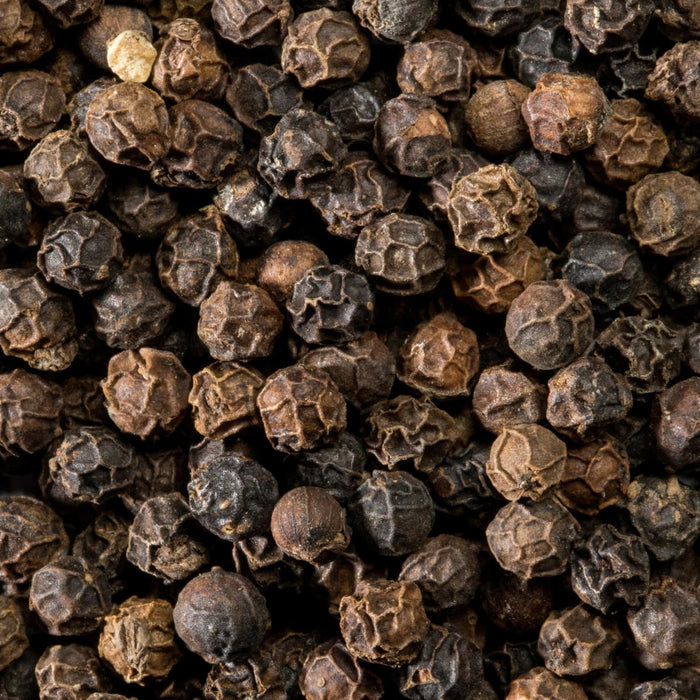A close-up view of dried black peppercorns.