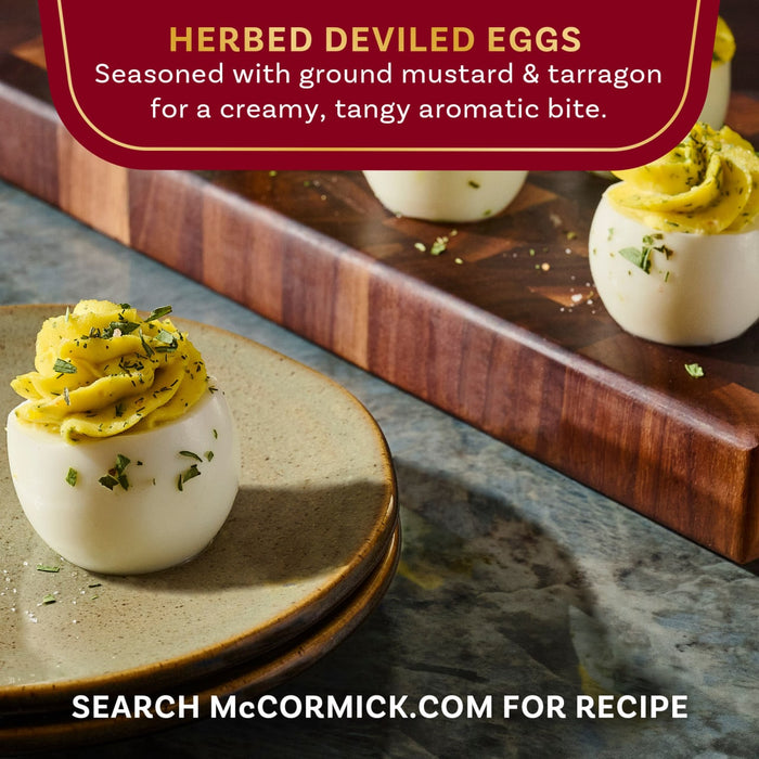 A close-up shot of McCormick Herbed Deviled Eggs seasoned with ground mustard and tarragon, showcasing a creamy, tangy, and aromatic bite.