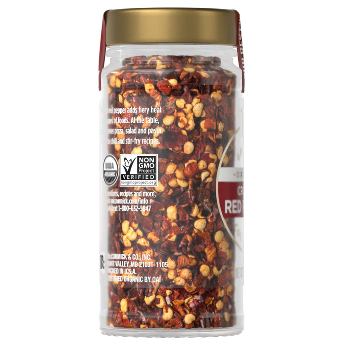 A jar of McCormick Organic Crushed Red Pepper is shown, highlighting its vibrant color and texture.