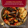 This is an image of McCormick's Mussels Fra Diavolo, steamed mussels served with a spicy tomato sauce and charred torn baguette.
