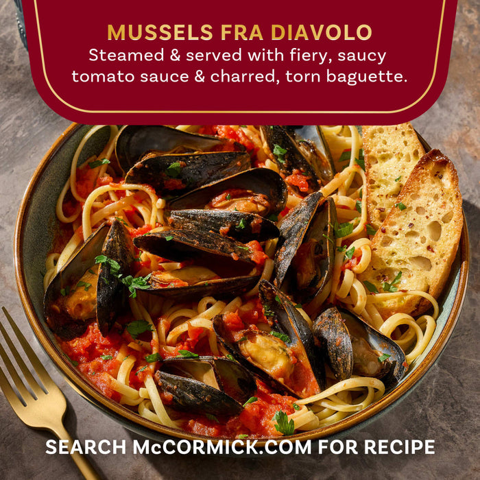 This is an image of McCormick's Mussels Fra Diavolo, steamed mussels served with a spicy tomato sauce and charred torn baguette.