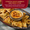 McCormick presents a plate of scratch-made hummus with fresh pita bread.