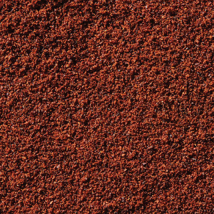A close-up texture of reddish-brown granules, possibly representing a surface or material.