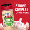 A jar of McCormick Garlic Powder with a garlic bulb in the foreground.