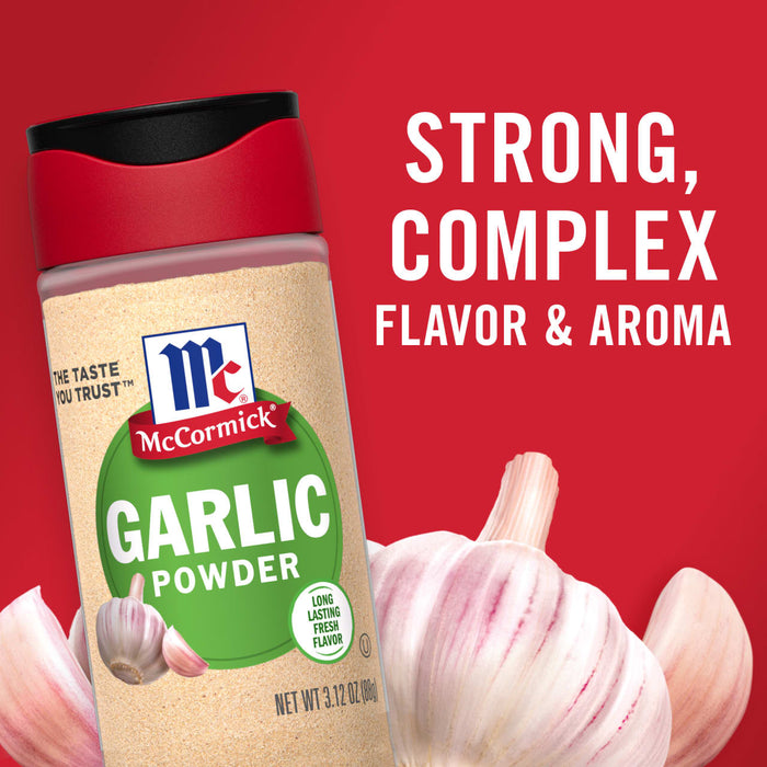 A jar of McCormick Garlic Powder with a garlic bulb in the foreground.