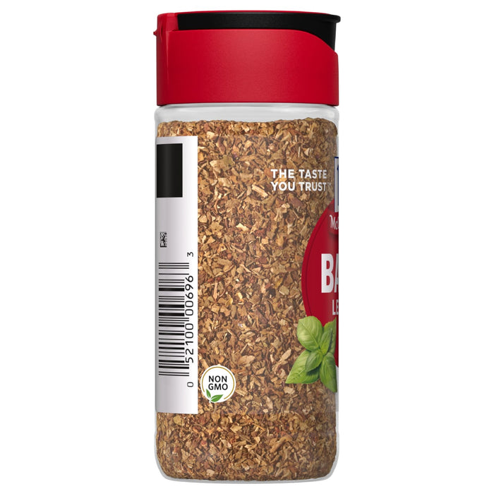 A McCormick jar of dried basil leaves.