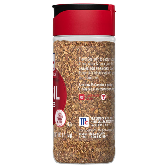 A McCormick jar of dried basil leaves.