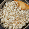 A wooden spoon rests in a bowl of fluffy white rice that has been seasoned with Mccormick Everything Bagel Seasoning Assorted Form 4.8 Oz.