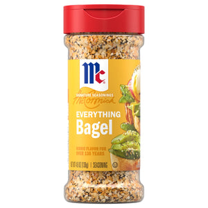 A clear bottle of Mccormick Everything Bagel Seasoning Assorted Form 4.8 Oz is displayed with its signature red cap and yellow label, which features a serving suggestion of avocado toast.