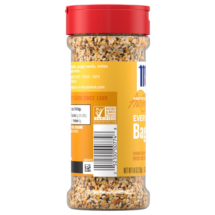 A side view of a clear bottle of Mccormick Everything Bagel Seasoning Assorted Form 4.8 Oz, showing the blend of sesame seeds, poppy seeds, garlic, and onion, along with the nutritional information and Non-GMO Project Verified seal.