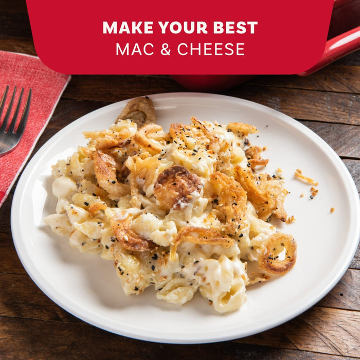 A plate of creamy macaroni and cheese is topped with crispy fried onions and a generous sprinkle of Mccormick Everything Bagel Seasoning Assorted Form 4.8 Oz.