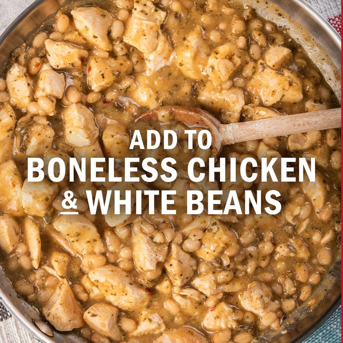 A skillet filled with boneless chicken and white beans, suggesting a hearty and flavorful meal.