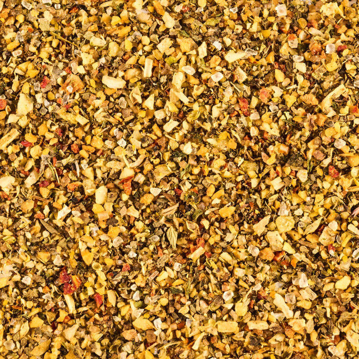 A close-up shot reveals a vibrant mix of dried herbs and spices, showcasing a variety of textures and colors.