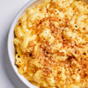 A bowl of macaroni and cheese with a crispy breadcrumb topping.
