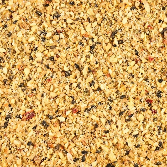 A close-up shot reveals a mixture of finely ground spices and herbs, creating a textured and colorful blend.