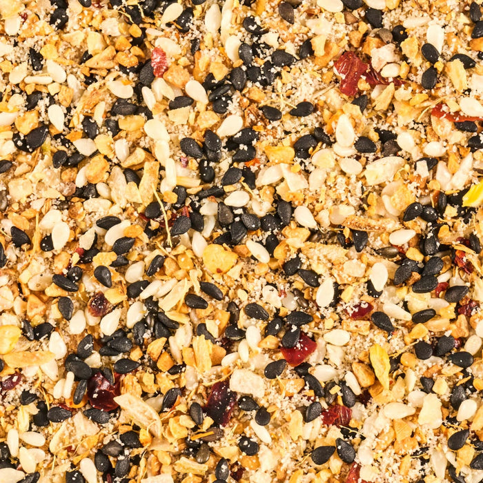 A close-up shot of everything bagel seasoning, showcasing its diverse mix of sesame seeds, dried garlic, dried onion, salt, poppy seeds, and spices.
