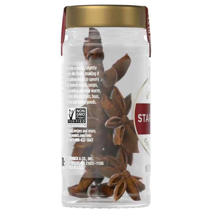 The back of a clear jar of Mccormick Gourmet, 0.42 Oz reveals whole star anise pods and label information, including the Non-GMO Project Verified seal.