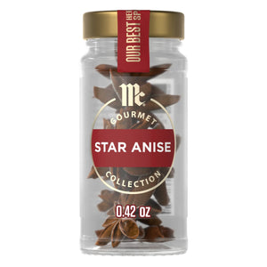 A clear glass jar of Mccormick Gourmet, 0.42 Oz, is filled with whole star anise pods and shown against a white background.
