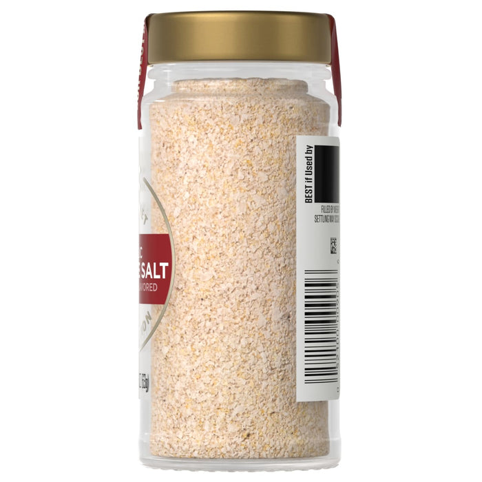 A side view of a clear glass Mccormick Gourmet, 2.25 Oz jar of garlic salt, showing the granulated texture of the spice and the product information label.