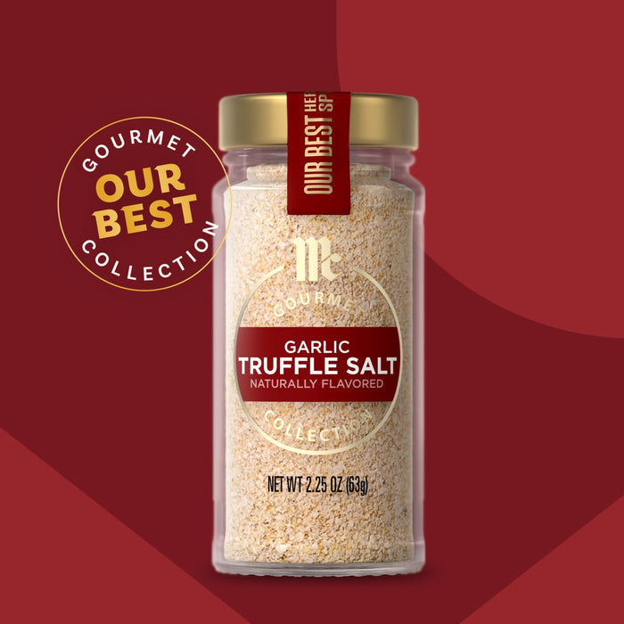 A glass jar of Mccormick Gourmet Garlic Truffle Salt, 2.25 Oz, is centered against a stylized red background.