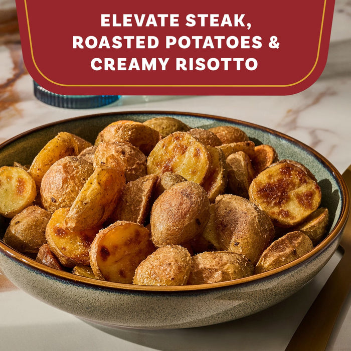 A rustic bowl of golden roasted potatoes suggests a delicious use for Mccormick Gourmet Garlic Truffle Salt, 2.25 Oz.