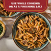 A delicious bowl of creamy mushroom penne pasta is shown as a serving suggestion for the Mccormick Gourmet Garlic Truffle Salt, 2.25 Oz, which can be used while cooking or as a finishing salt.