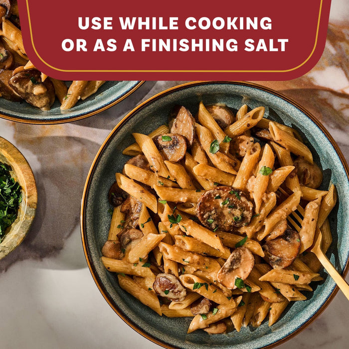 A delicious bowl of creamy mushroom penne pasta is shown as a serving suggestion for the Mccormick Gourmet Garlic Truffle Salt, 2.25 Oz, which can be used while cooking or as a finishing salt.