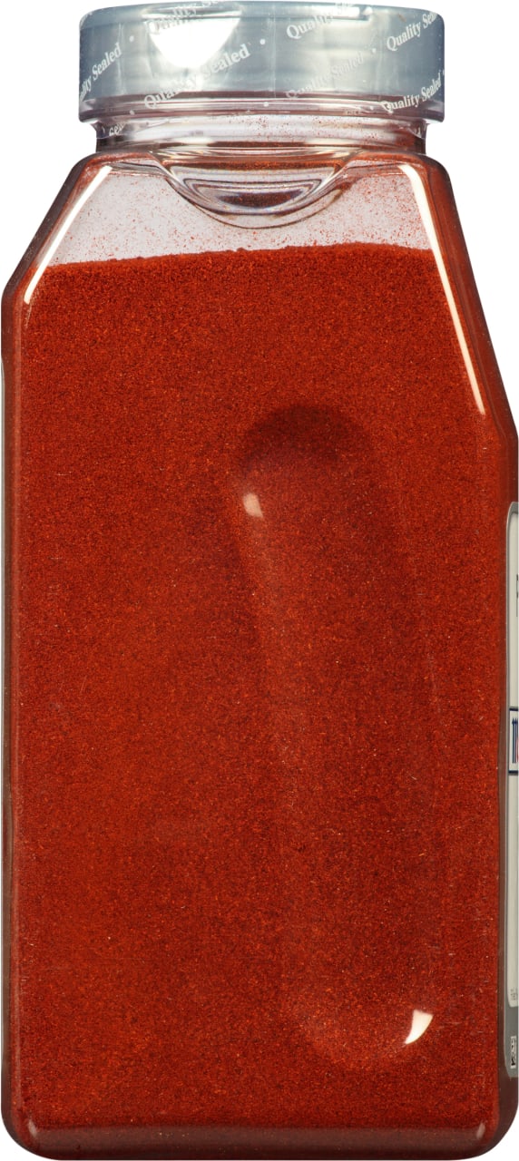A clear plastic jar filled with red paprika.