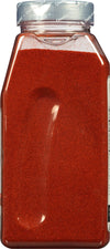 A clear plastic jar filled with red chili powder.