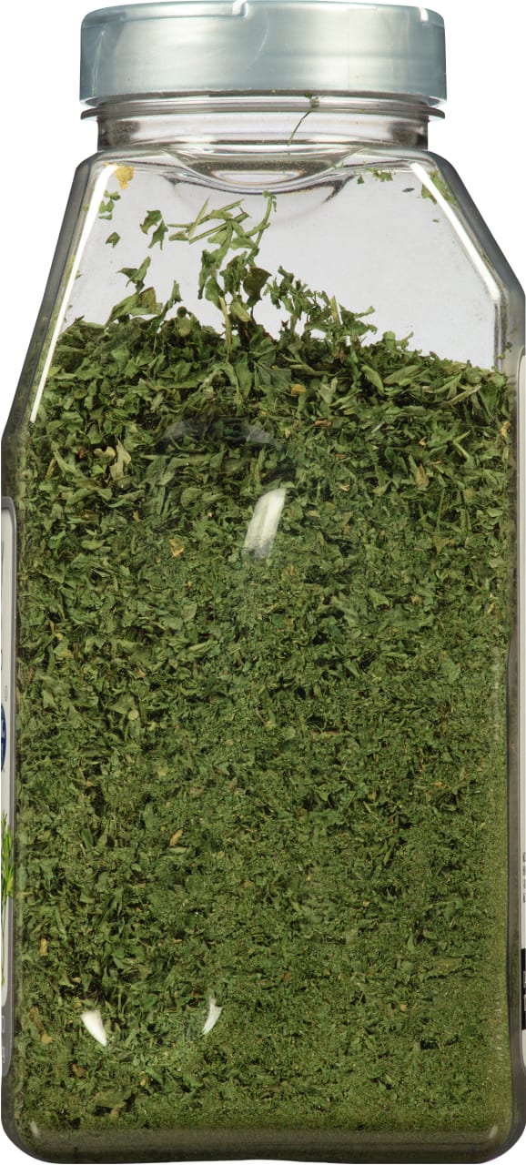 A clear plastic jar filled with dried parsley.