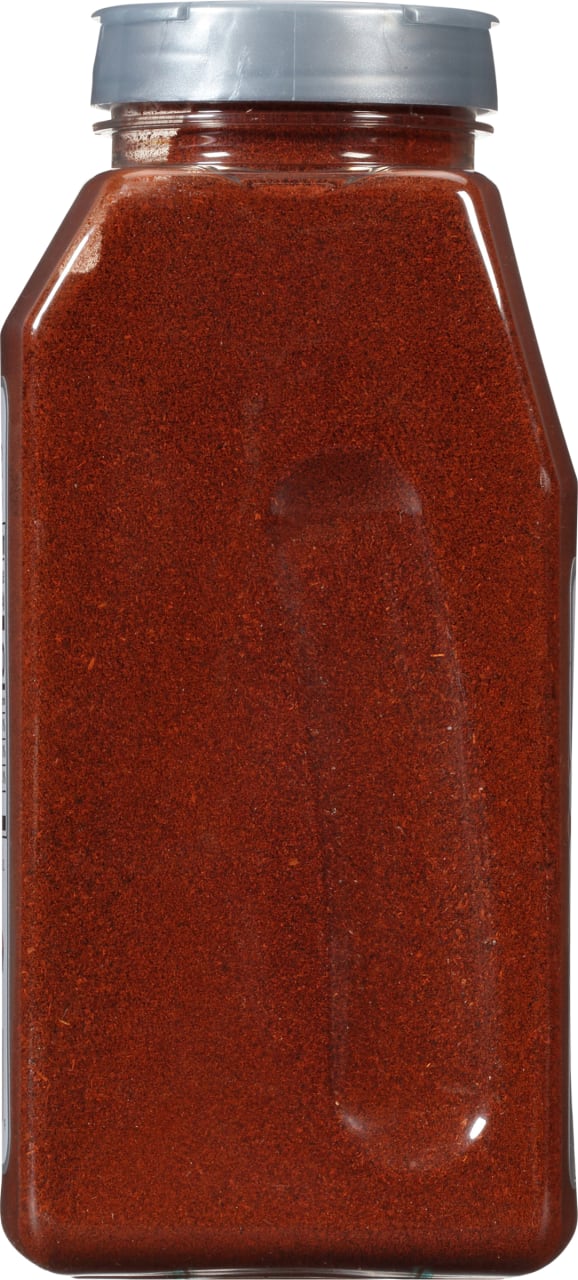 A glass jar of red chili powder.