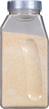 A clear plastic jar filled with granulated garlic.